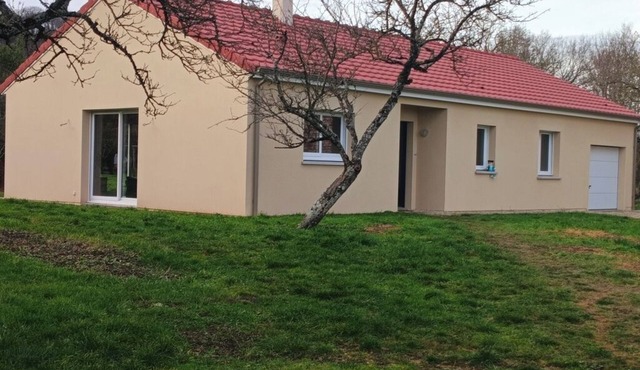 single-storey house on large wooded grounds